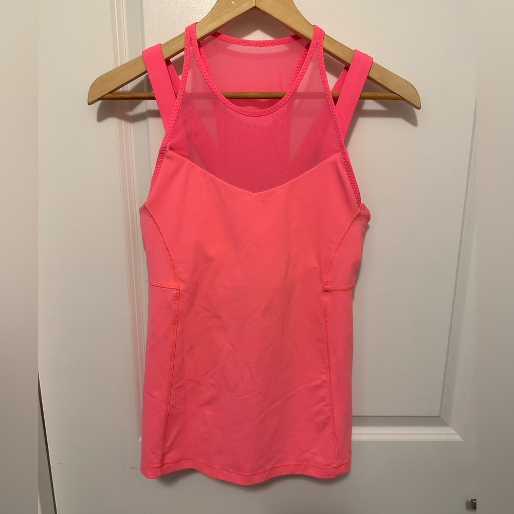Lululemon size 6 coral tank. Can add padding. Excellent condition.